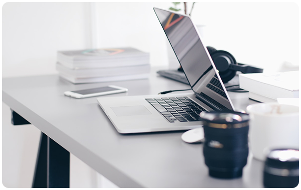 Laptop on desk with coffee
